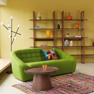 living room with yellow walls and green sofasets