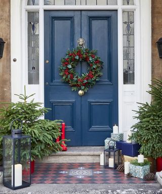 dark blue Victorian front door with tiled doorstep