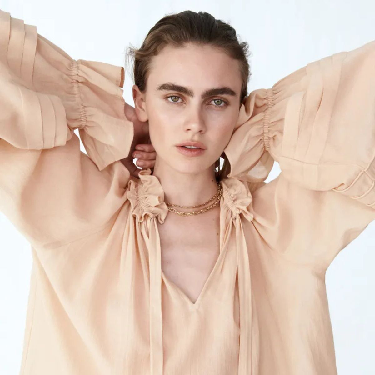 Woman wears pink blouse from H&amp;M summer collection