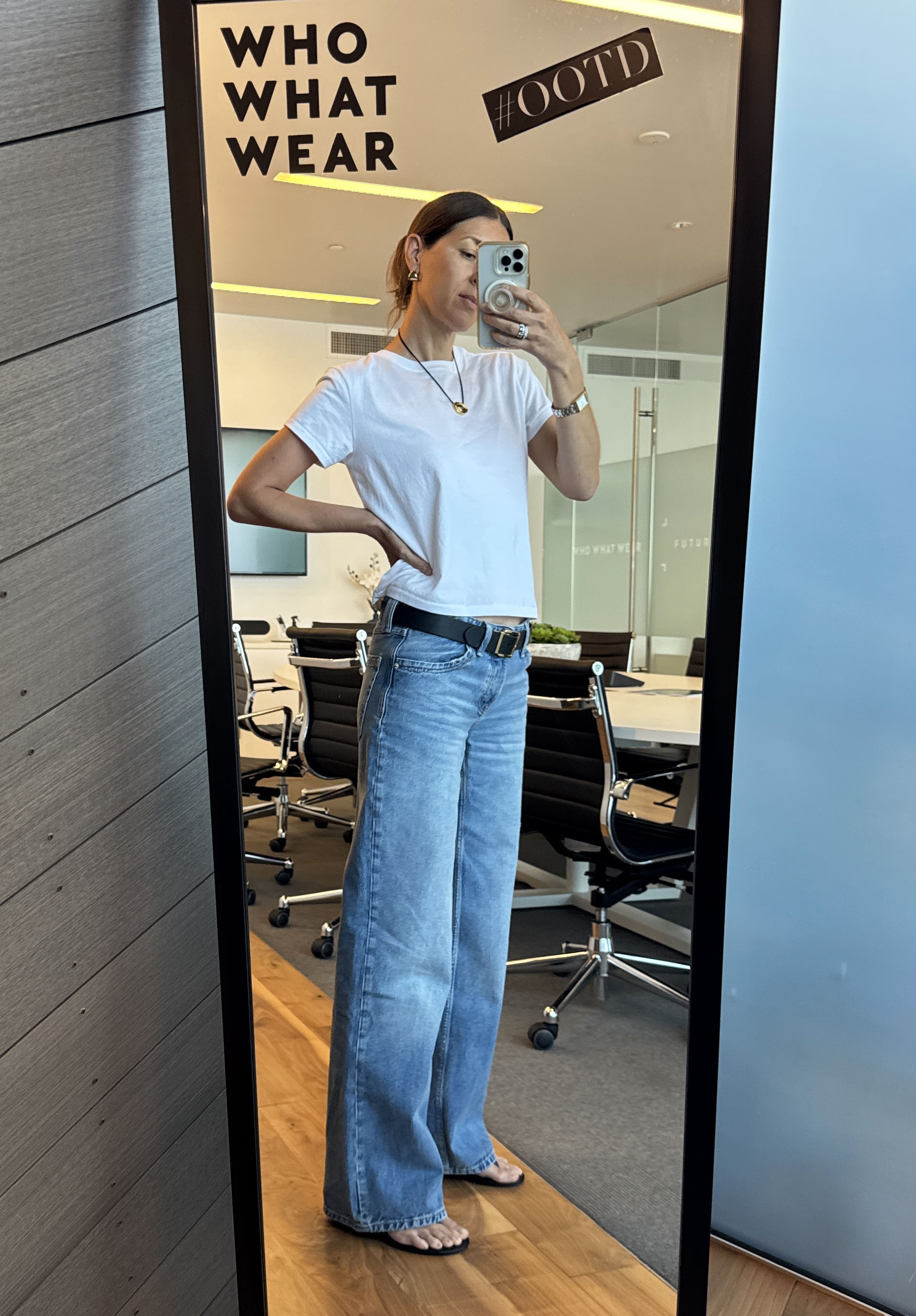 Woman in white t-shirt and jeans.