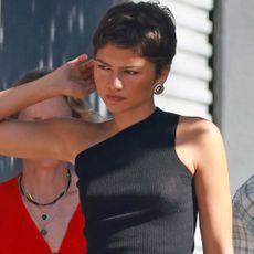 Zendaya styled a tank top with a black skirt from Prada and matching leather boots for fall