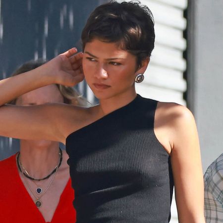 Zendaya styled a tank top with a black skirt from Prada and matching leather boots for fall