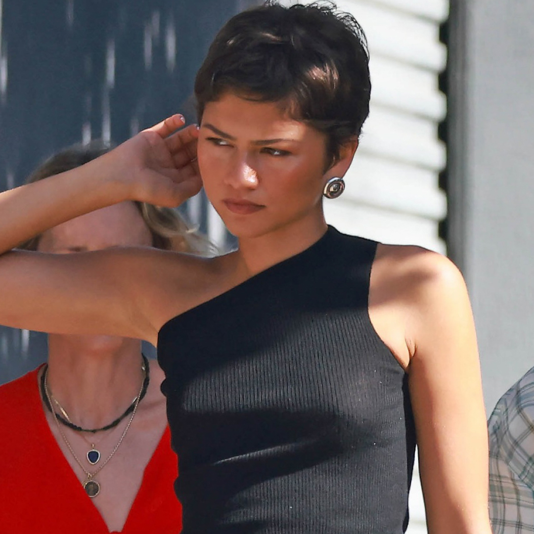 Zendaya styled a tank top with a black skirt from Prada and matching leather boots for fall