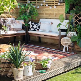 Garden seating corner with potted plants by patio