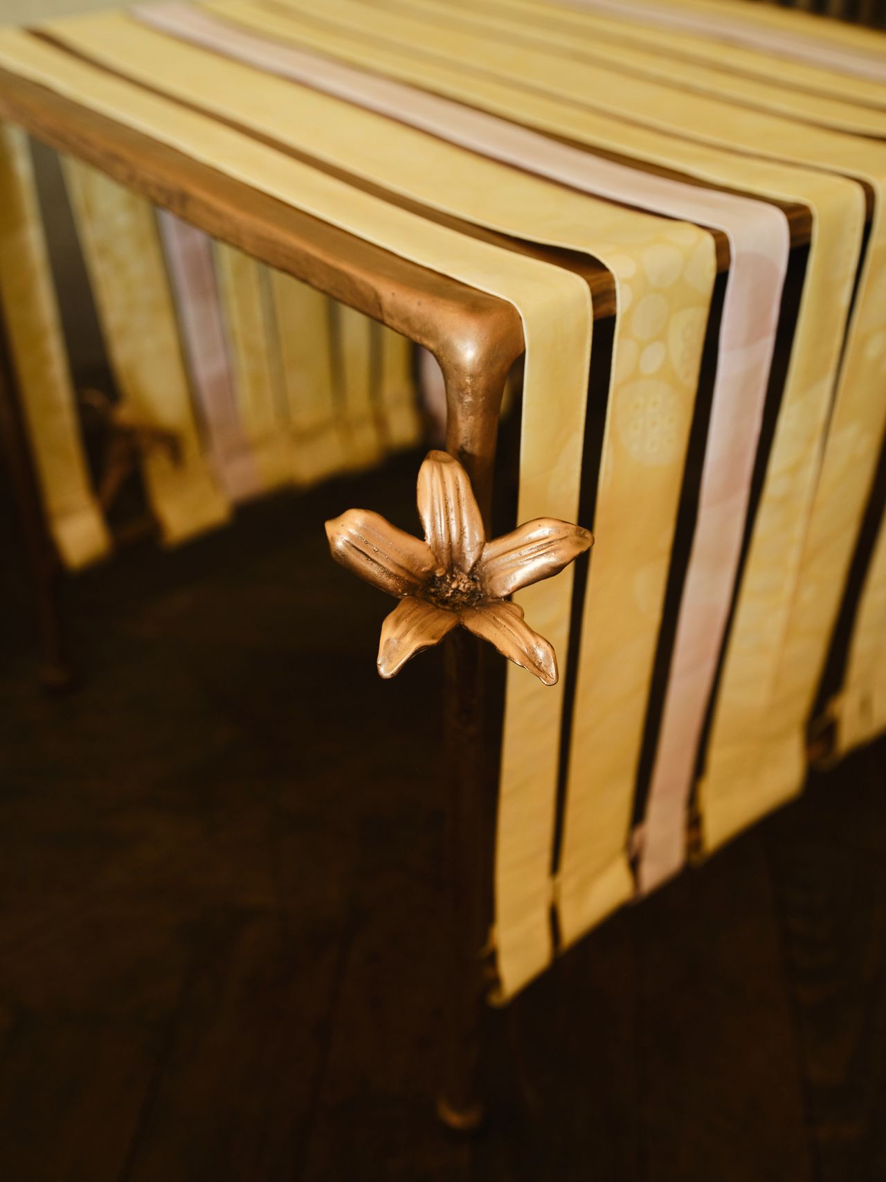 bronze furniture draped in pastel ribbons