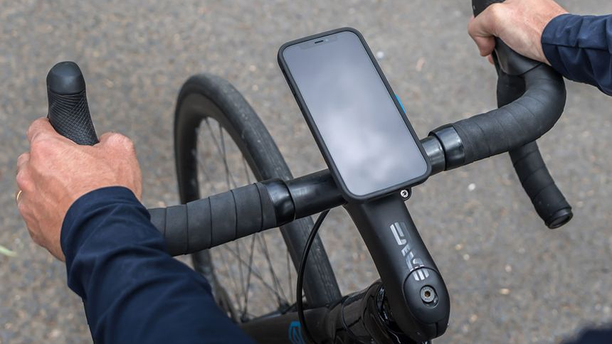 An iPhone mounted to a bike's handlebars