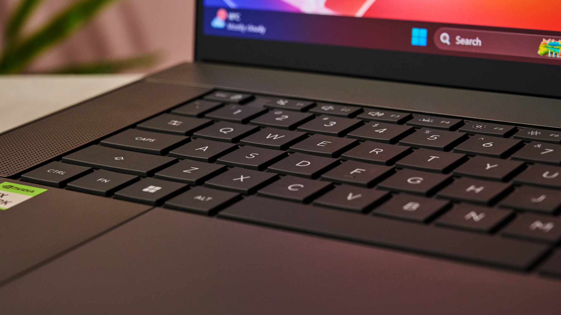 A closeup of the Asus ProArt P16 RTX Spark's keyboard, trackpad and a small section of its display.