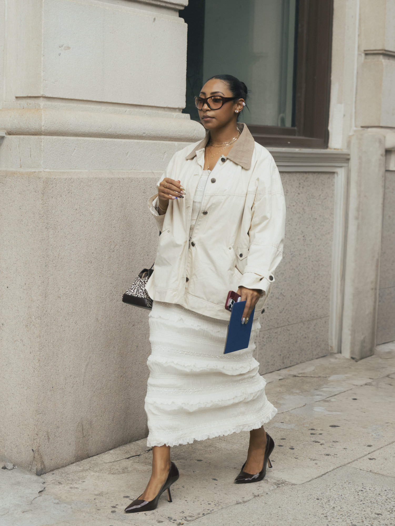 woman wearing cream jacket and cream skirt