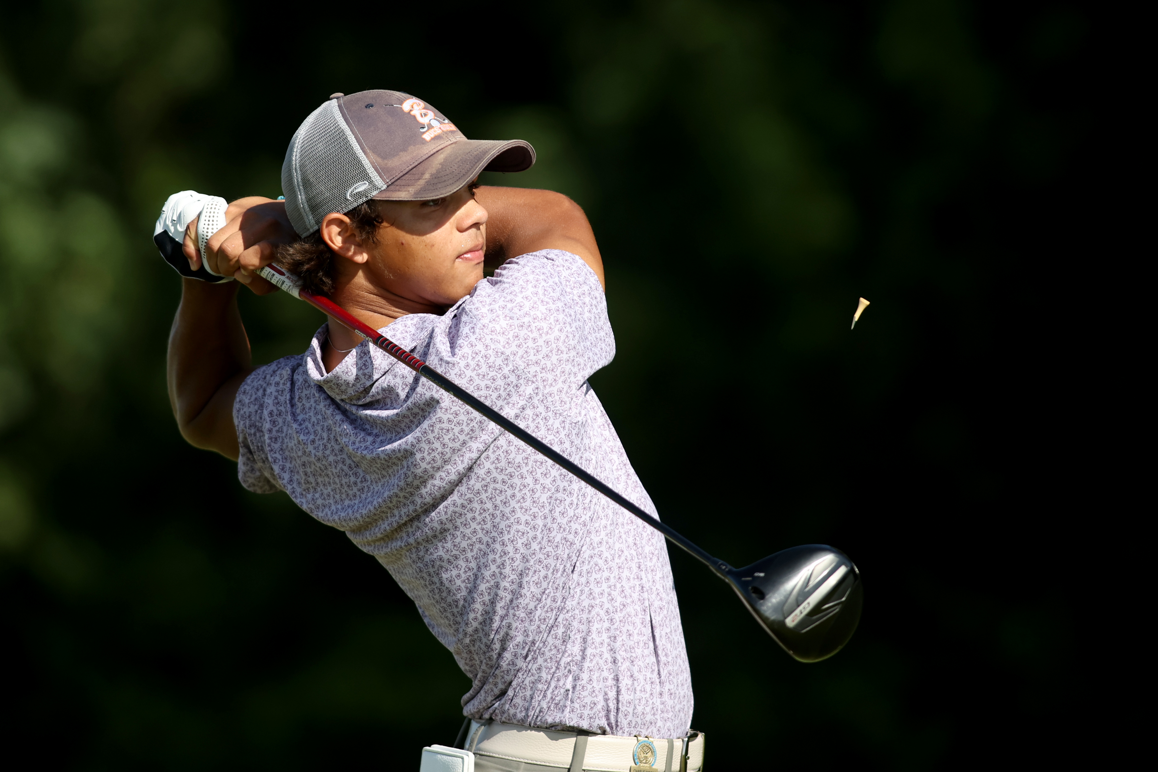 Charlie Woods of the United States hits a tee shot on the fourth hole during the second round of the U.S. Junior Amateur at Trinity Forest Golf Club on July 22, 2025 in Dallas, Texas