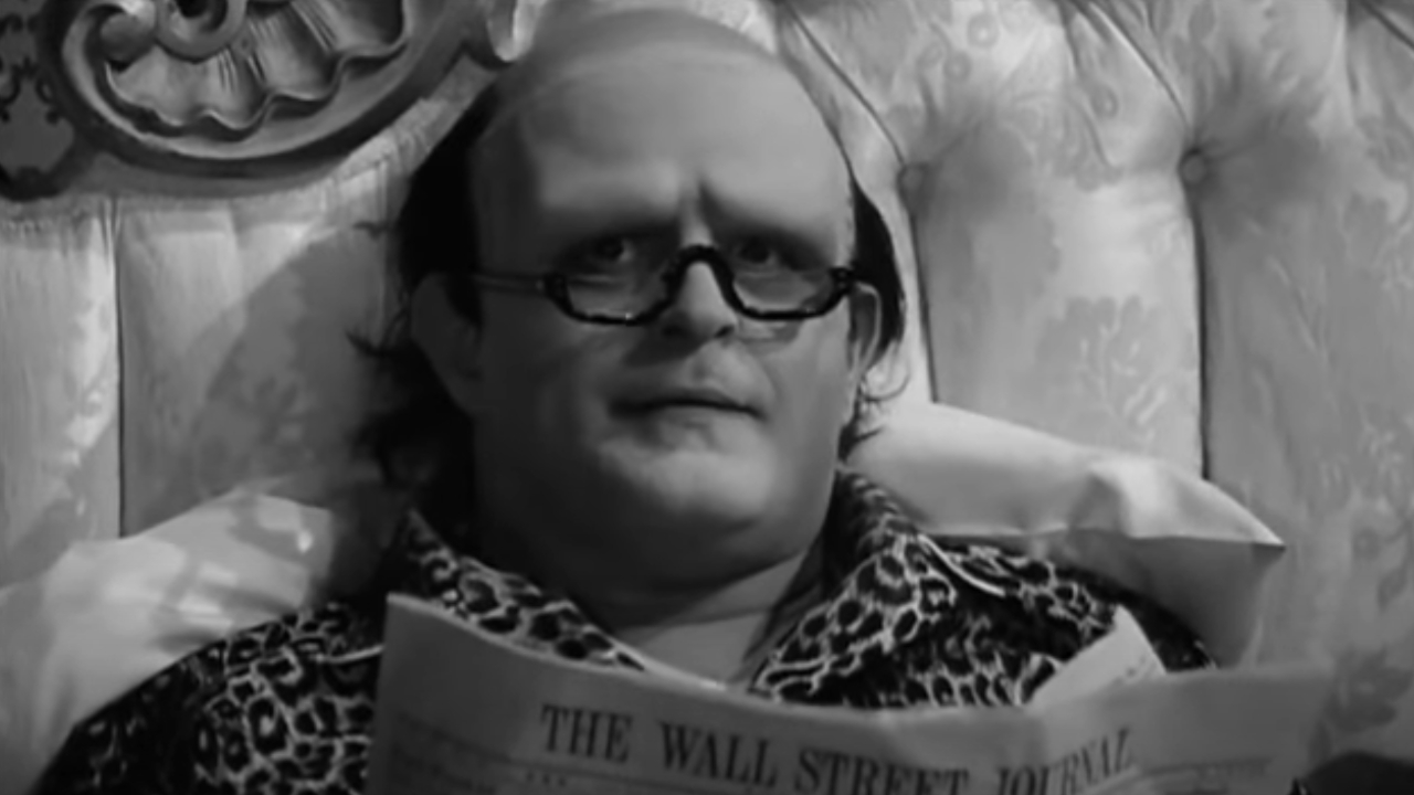 Peter Boyle reads a newspaper in bed as the Monster in Young Frankenstein.
