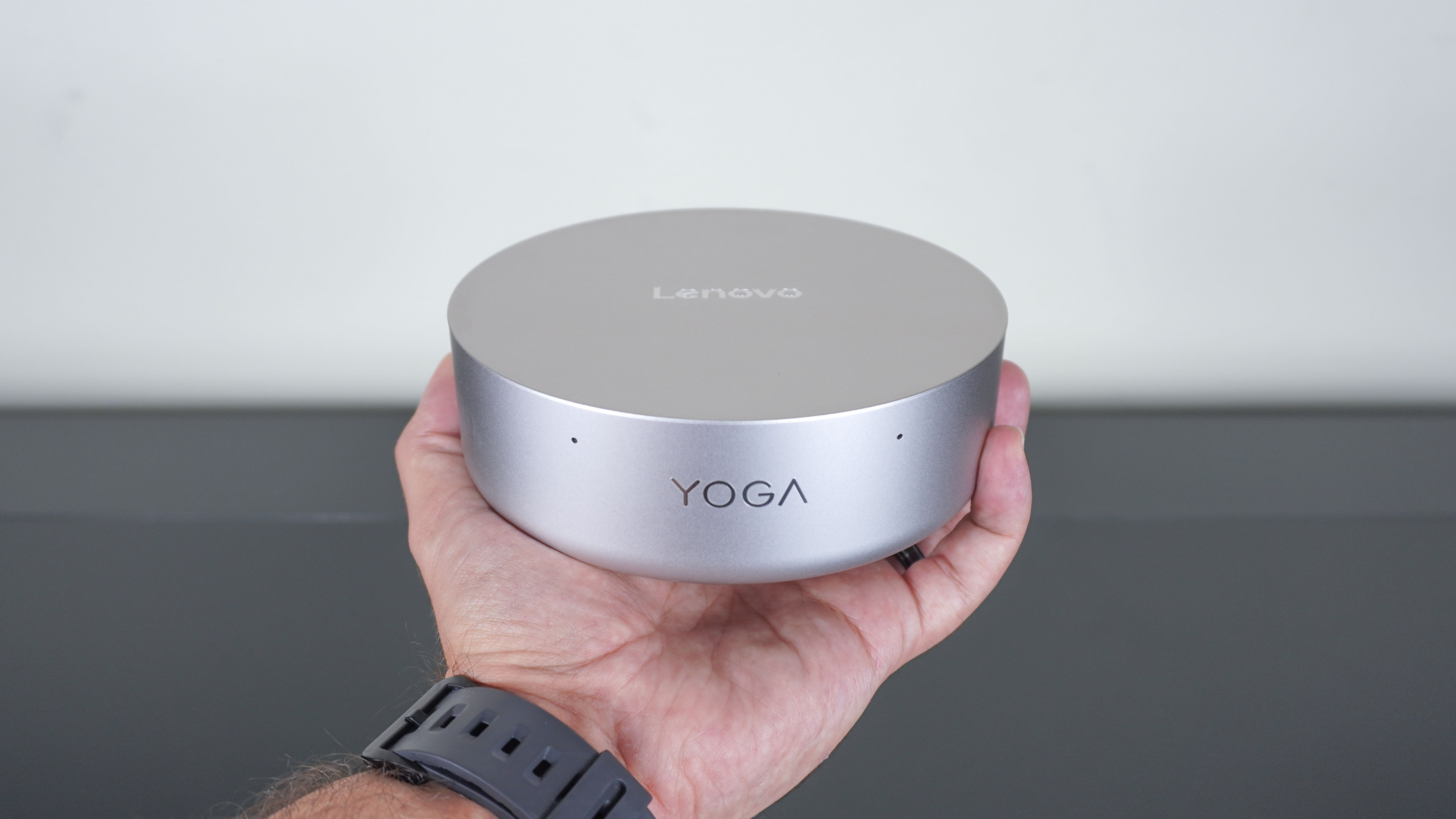 A person holding the Lenovo Yoga Mini in the palm of their hand