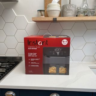 Instant Vortex Plus 6-in-1 Air Fryer in box on kitchen counter
