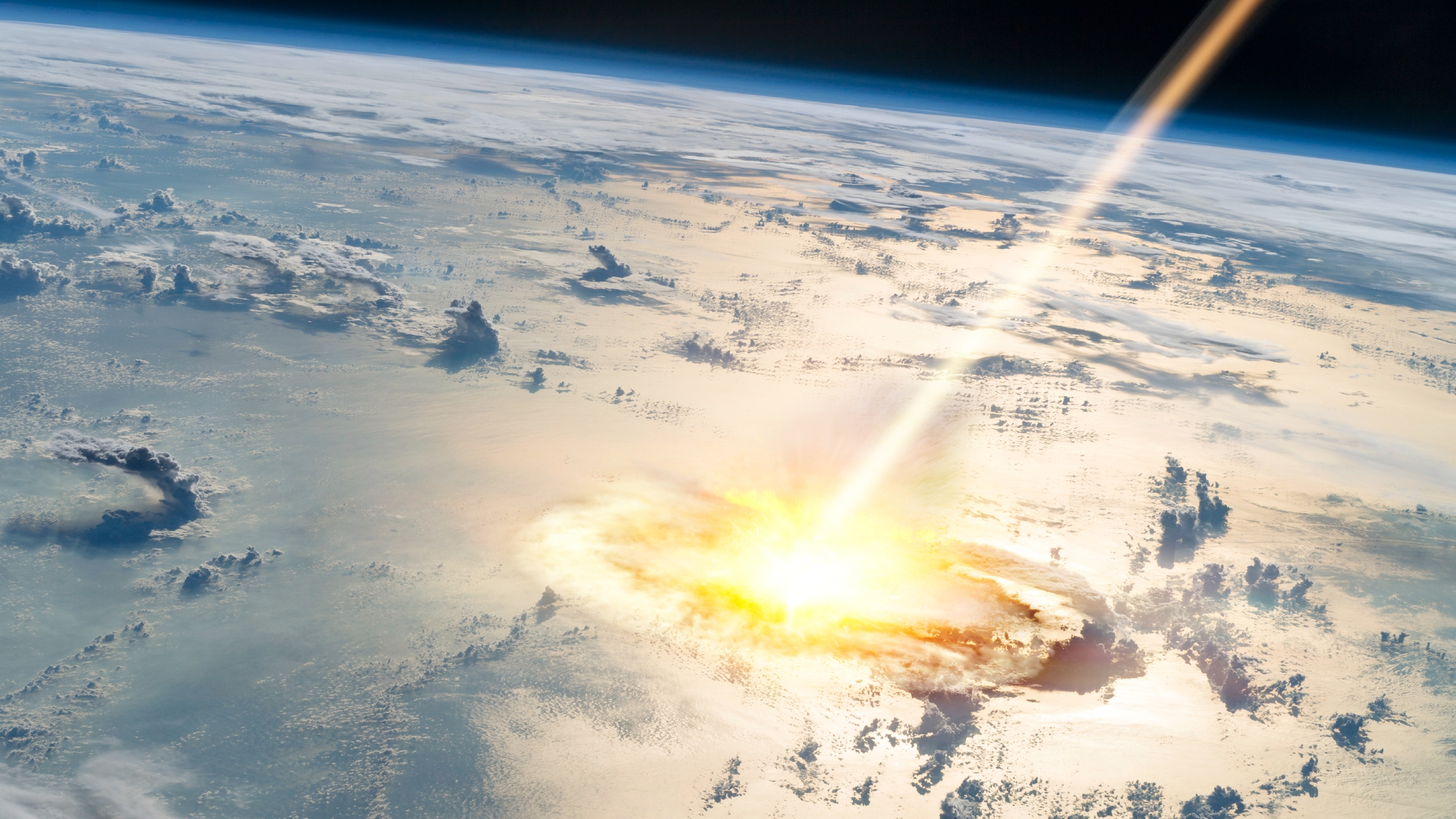 An artist's illustration of a large meteor striking Earth in the middle of the ocean