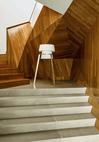 Paper folded room with wooden staircase and white lamp