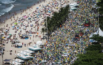 Protesters march on Copacabana beach.