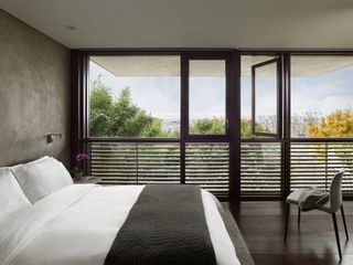 Bedroom with large glazing and shades