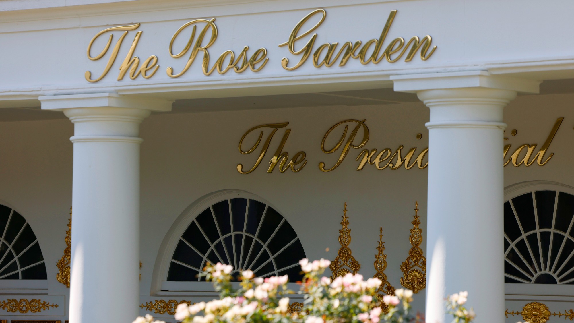 Gold letters at the White House spell out 'The Rose Garden'