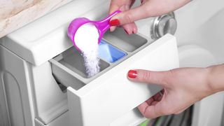 Powder detergent being added to a detergent draw in a washing machine