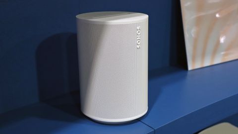 Sonos Era 100 speaker on a blue shelf