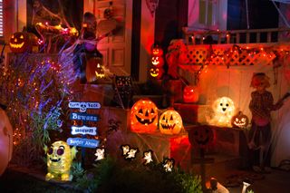 A house with Halloween decorations at night.