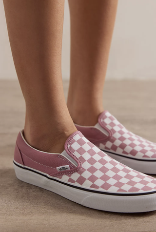 a model wears a pair of checkered vans sneakers in a guide to gigi hadid's summer outfit