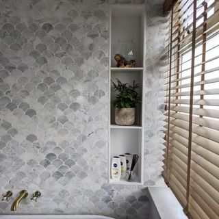 Scallop-edged tiles in grey with storage holes