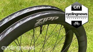 A pair of black Zipp 303 wheels next to each other on some grass