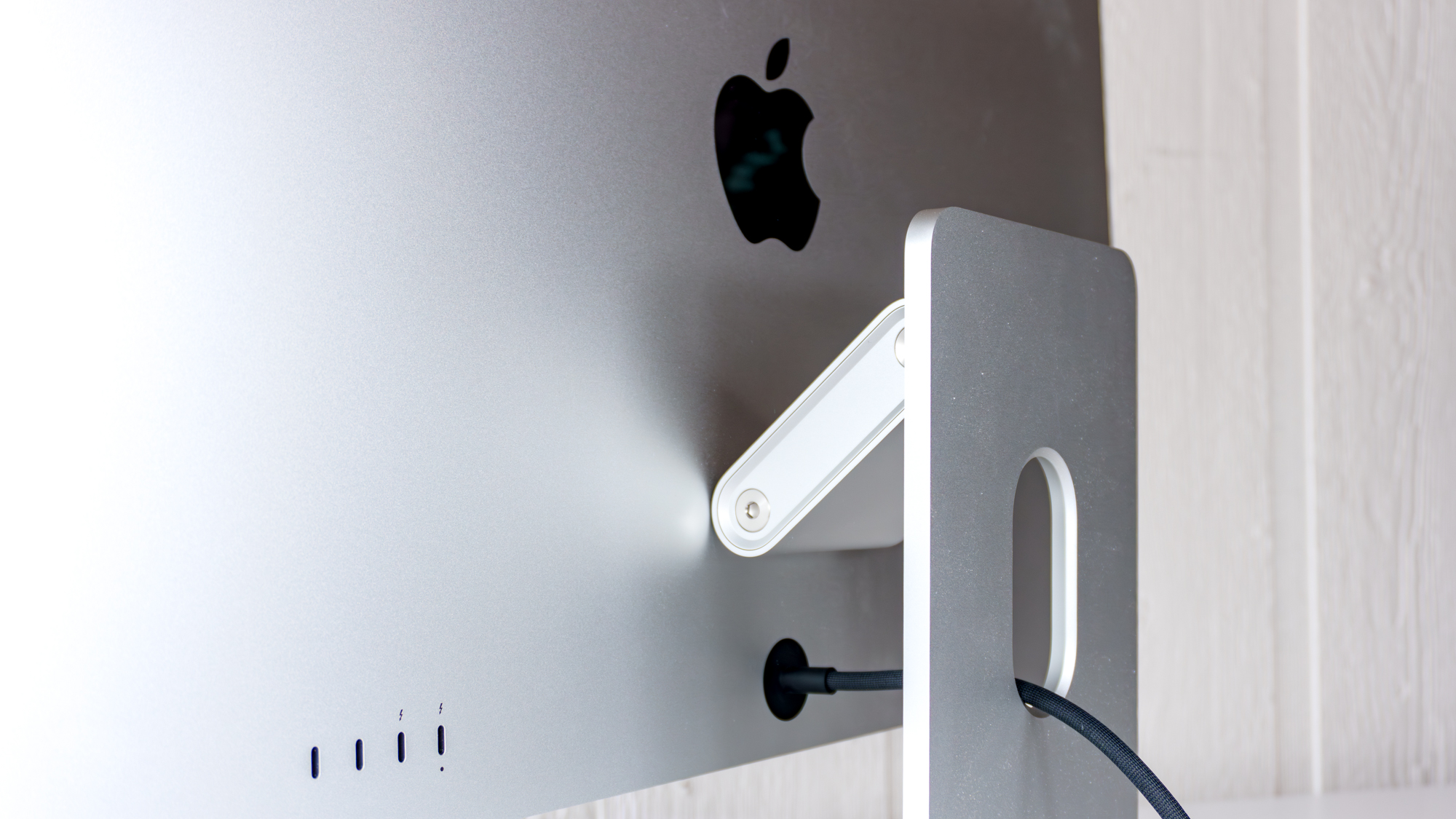 The back of the Apple Studio Display XDR showing its hardwired power cable and rear ports