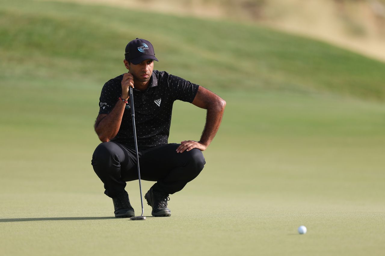 Aaron Rai lines up a putt