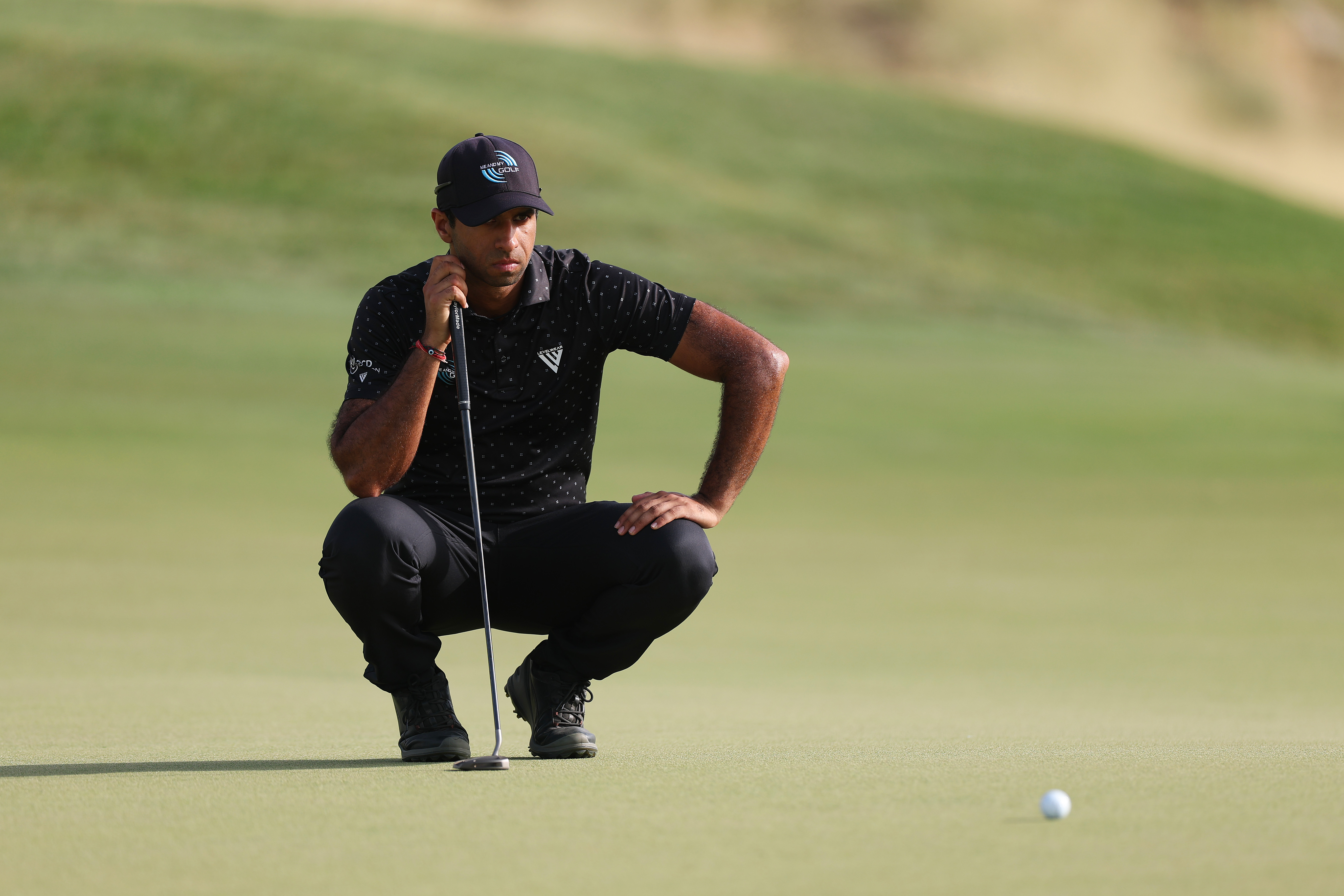 Aaron Rai lines up a putt
