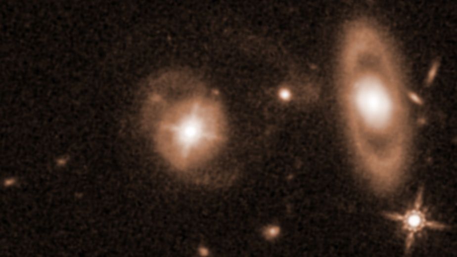 A sepia image of space, with two defined glowing structures.