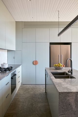 pastel blue kitchen with concrete floor