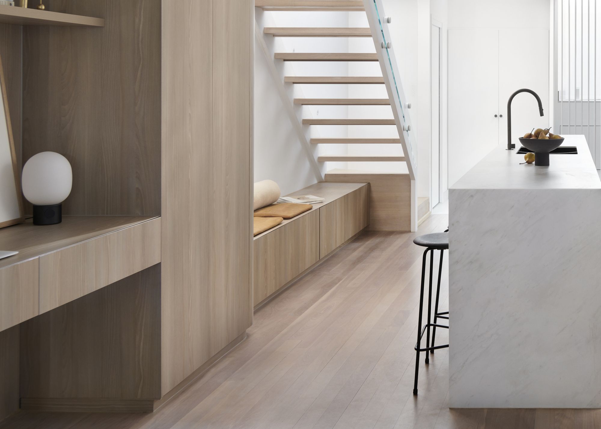 A small seating area under the stairs with added storage underneath