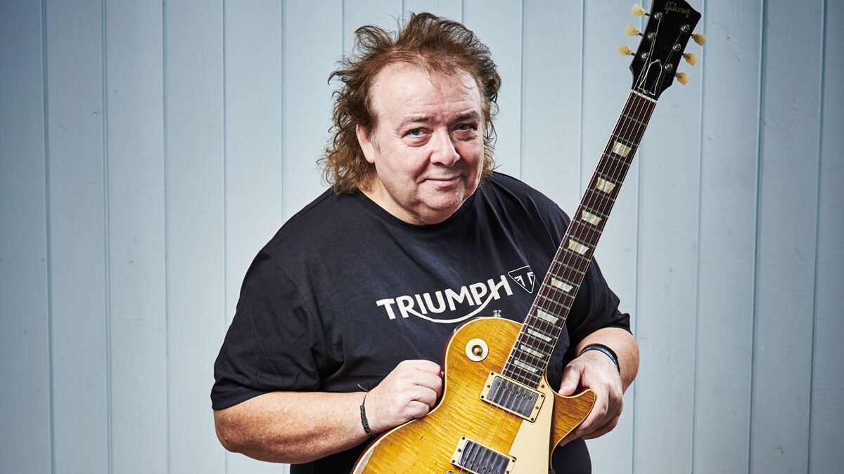 Bernie Marsden poses with a Gibson Les Paul