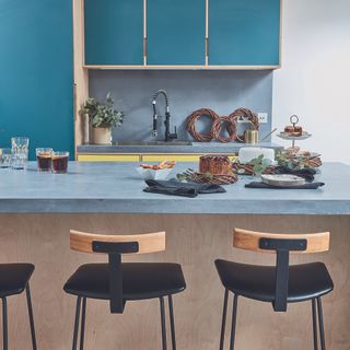 Blue modern Scandi kitchen with island and stool seating.