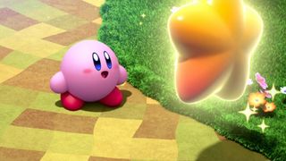 Kirby looking at a giant gold star in the Switch game Kirby and the Forgotten Land.