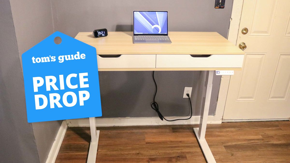 A RealSpace standing desk in a home office with a price drop badge