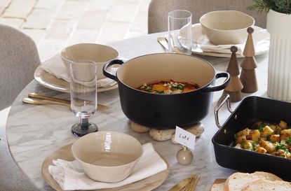 a dining table with cast iron cookware on