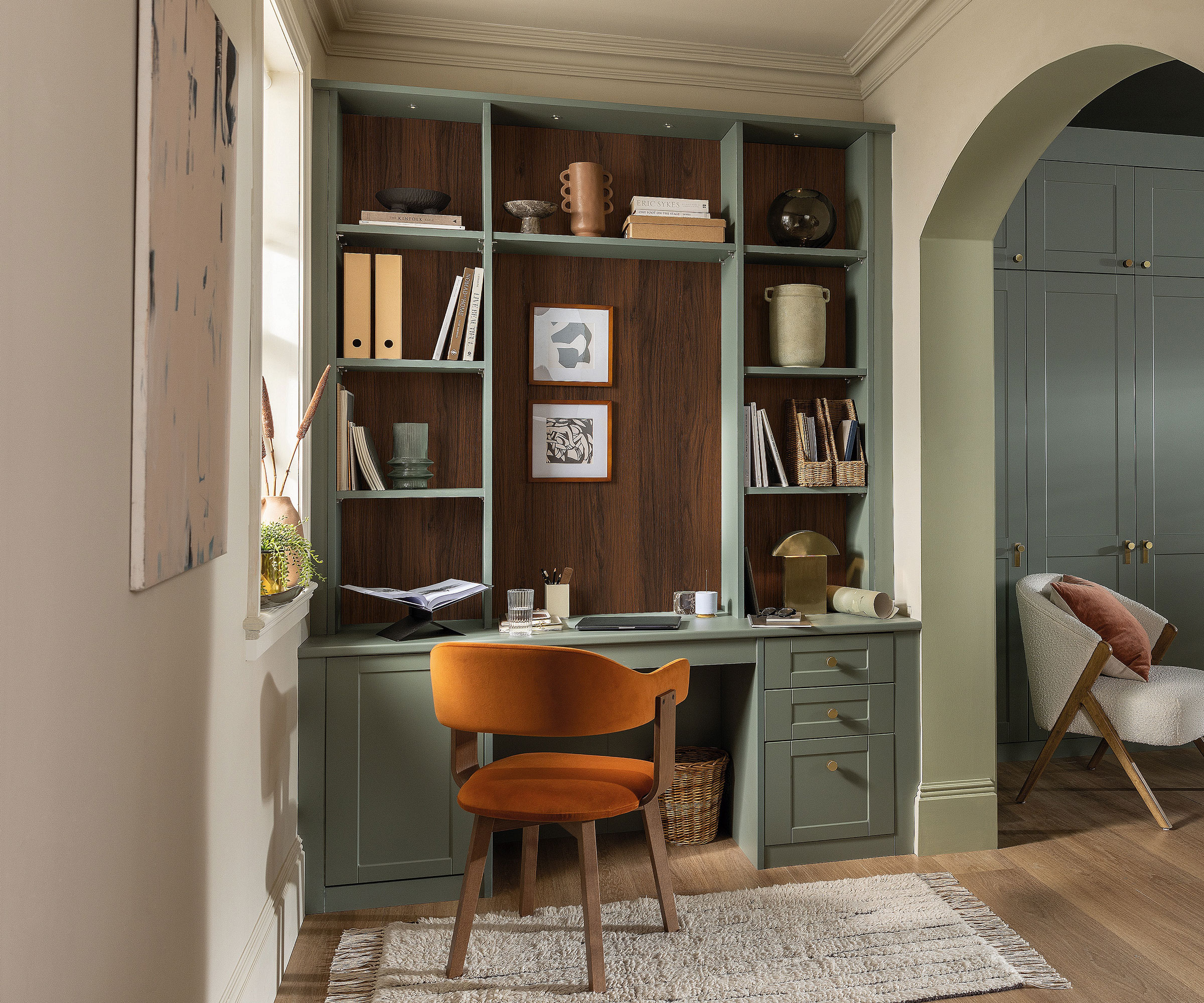fitted green home office with orange chairs