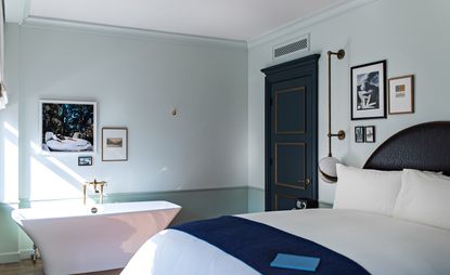 One of the bedrooms at the Nomad LA, featuring a rich Italianate palette of decorative gold and blue