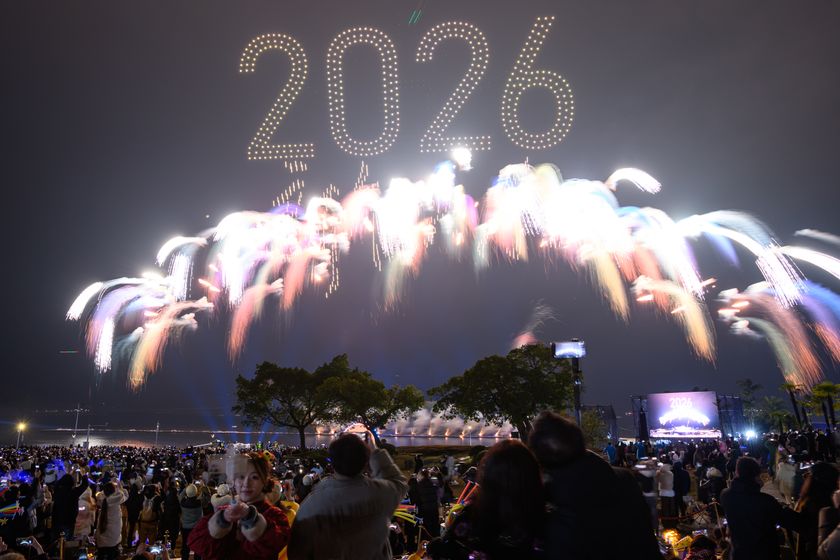 People cheer and take photos as a dazzling fireworks show lights up the sky over the Sky Theater to welcome the new year 2026 on January 1, 2026 in Chongqing, China. Various activities were held across China to celebrate the upcoming new year