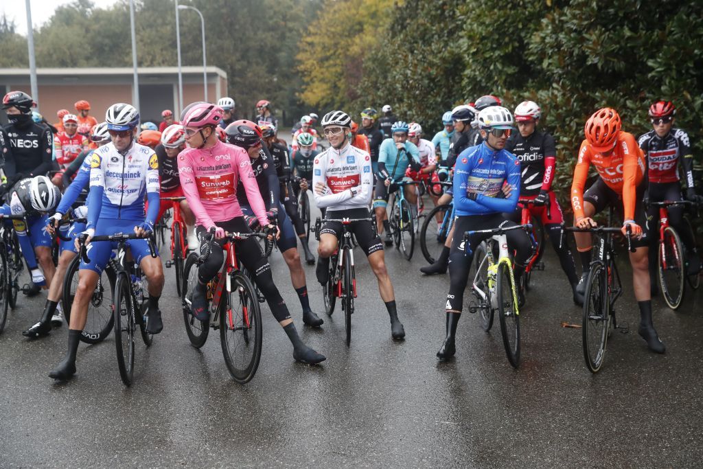 Riders wait in line before the start of the 19th stage of the Giro dItalia 2020 cycling race a 258kilometer route between Morbegno and Asti on October 23 2020 Heavy rain has interrupted on October 23 2020 the 19th stage of the Giro dItalia following protests by the riders in the face of difficult weather conditions Todays stage was planned to be a flat 258km ride between Morbegno and Asti but was cut back 100km after riders revolted when faced with pelting rain in the northern region of Lombardy Photo by Luca Bettini AFP Photo by LUCA BETTINIAFP via Getty Images