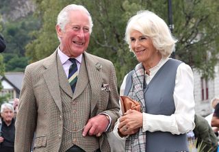 Prince Charles and Duchess Camilla smile while visiting Ballater, Aberdeenshire.