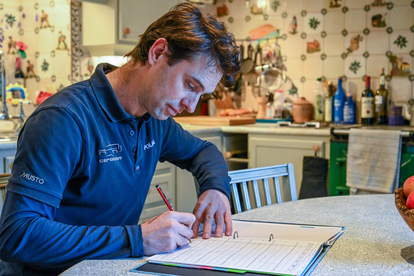 Harry Meade noting down fitness data in his tracker