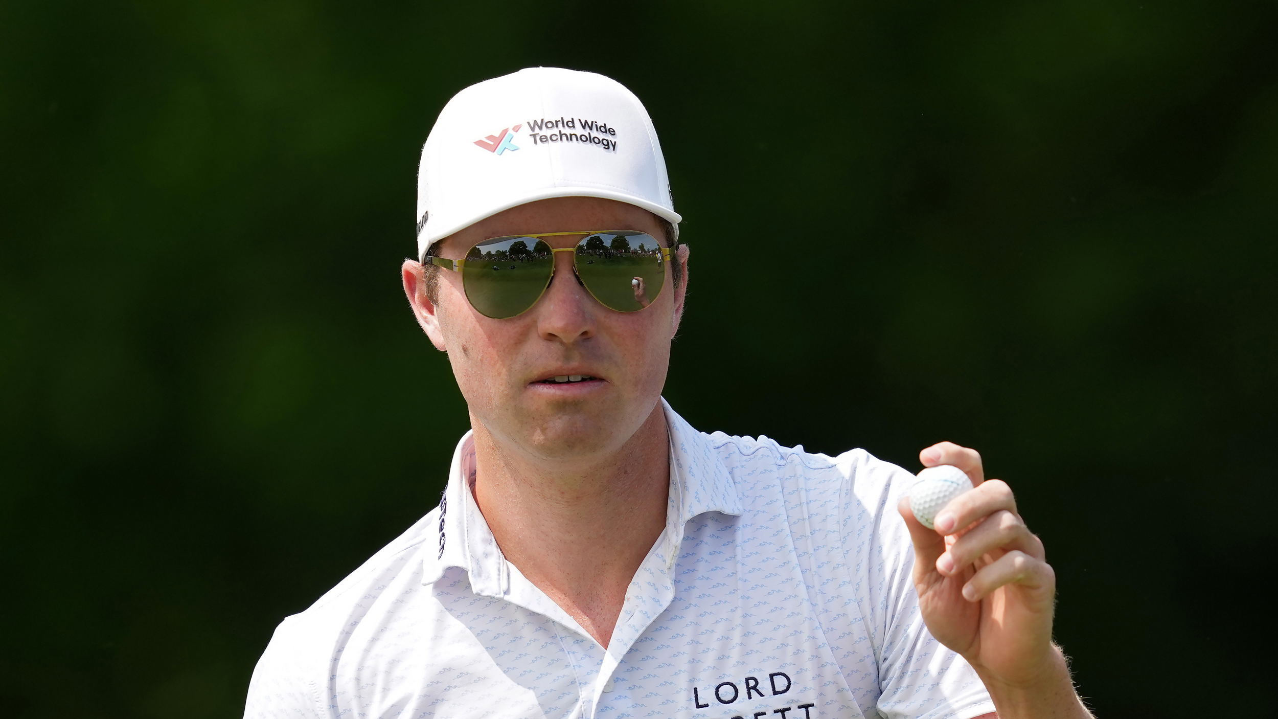 Ben Griffin - wearing his trademark sunglasses - holds his ball up to the crowd during round three of the Memorial Tournament in 2025