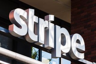 Stripe sign on a building with glass in the background