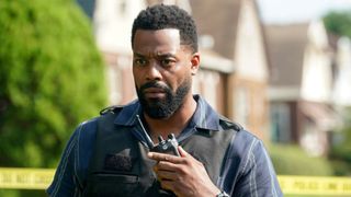 Atwater in his vest speaking into a walkie talkie on Chicago P.D.