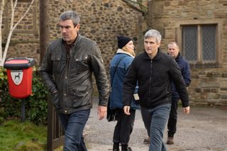 Cain Dingle looking cross and wearing a leather jacket in the village 
