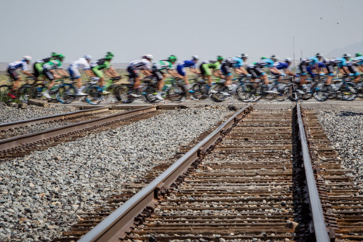 The peloton cross the train tracks
