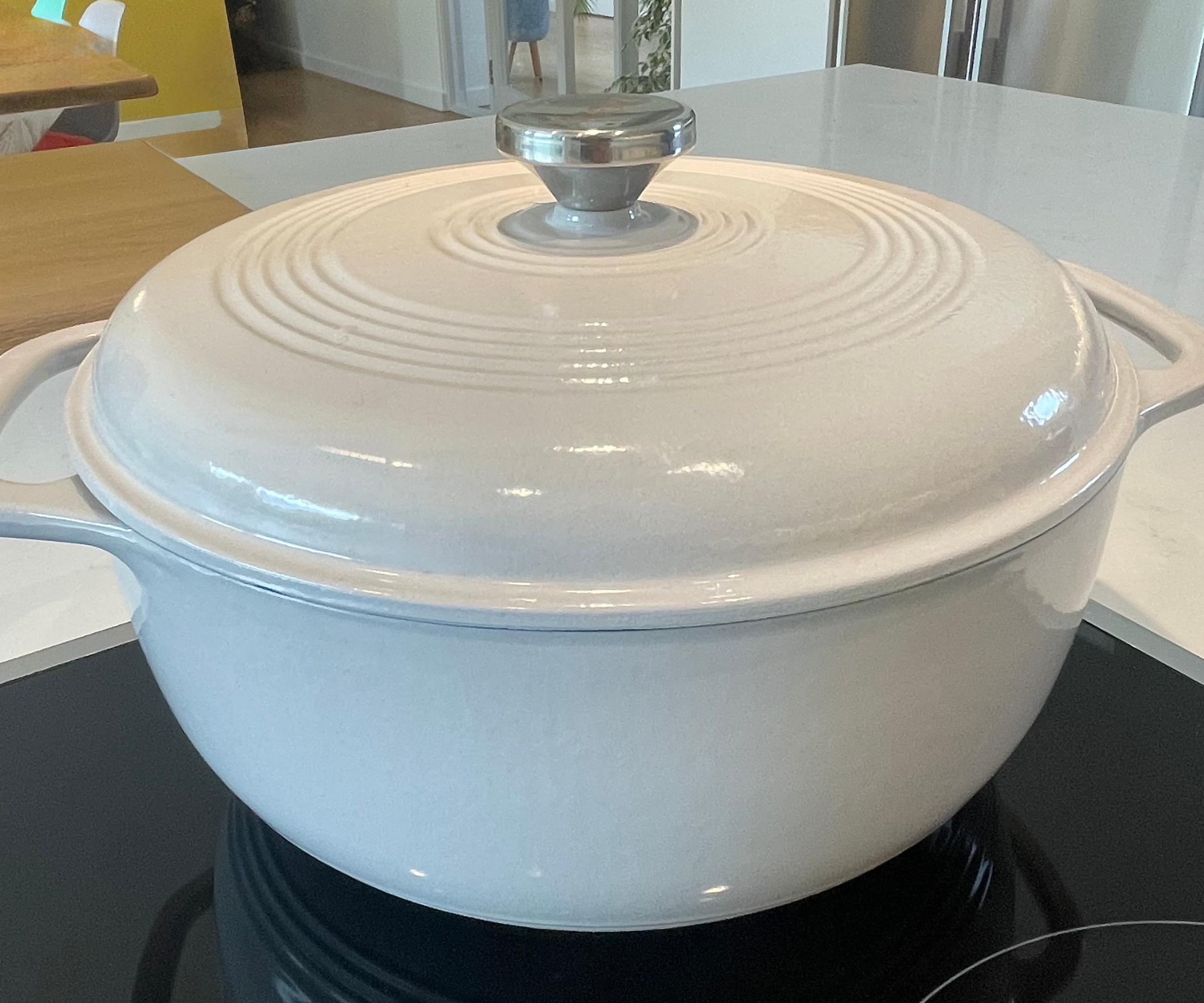 Lodge dutch oven in cream with a silver handle, on my induction hob